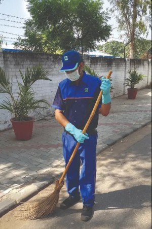 Sanitation worker sweeping a road