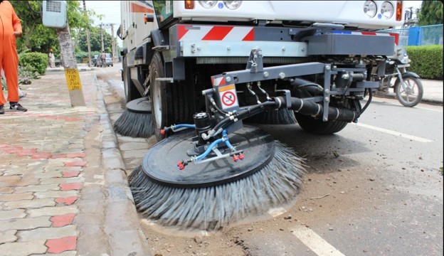 Sanitation worker sweeping a road