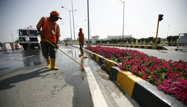 Sanitation worker sweeping a road